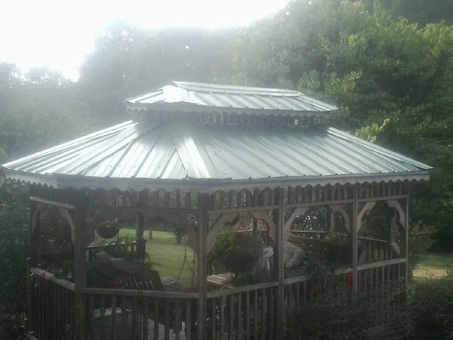 Two tier green metal roof on a garden gazebo in Winston